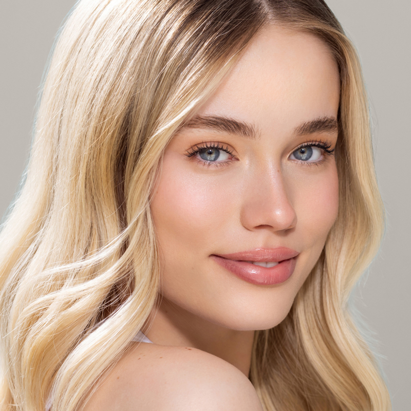 Woman with radiant skin looking directly at the camera.